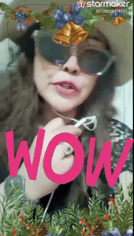 a woman wearing sunglasses and a hat with the word wow in pink