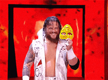a wrestler is holding a mask that says i am wy