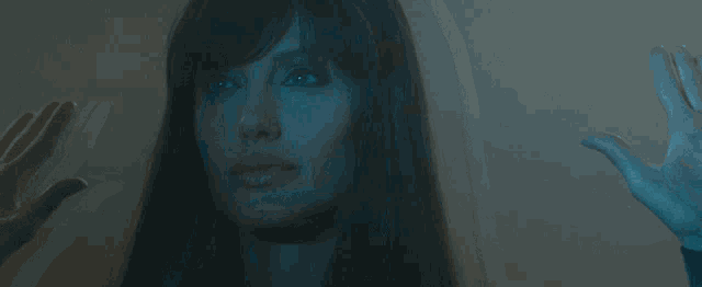 a close up of a woman 's face with blue hair