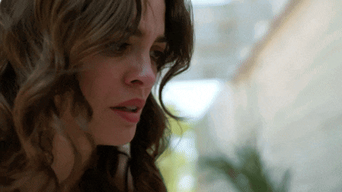 a close up of a woman 's face with a serious look on her face