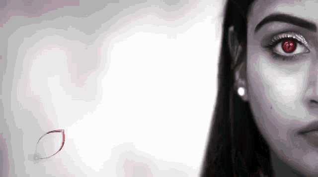 a close up of a woman 's face with red eyes