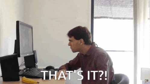 a man sits at a desk with a computer and the words that 's it behind him
