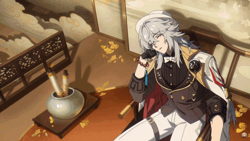 a man with gray hair is sitting in a chair