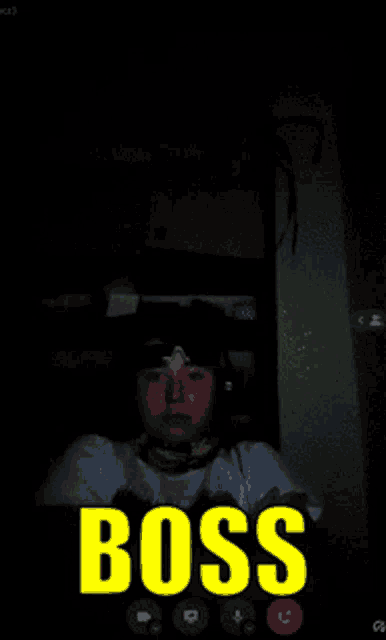a man wearing headphones is on a video call with the word boss in yellow