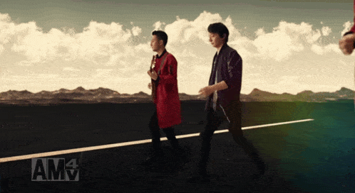 two men are walking down a road with amv written on the bottom