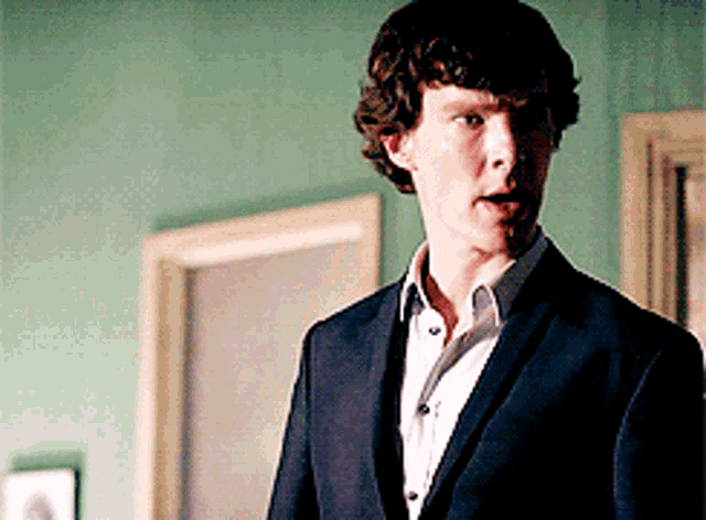 a man in a suit is standing in a room