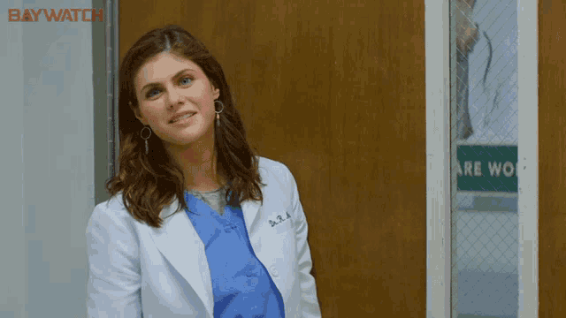 a woman in a lab coat with the name a.b.a on it