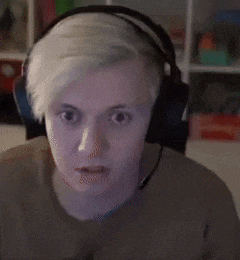 a man wearing headphones is making a funny face while looking at the camera .