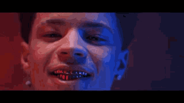 a close up of a man with braces on his teeth making a funny face .