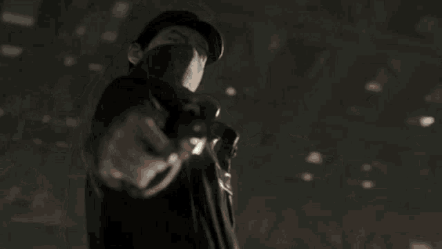 a man wearing a mask is pointing a gun at something