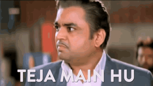 a man in a suit is making a funny face with the words teja main hu below him