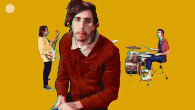a woman is standing in front of a drum set while a man plays drums .