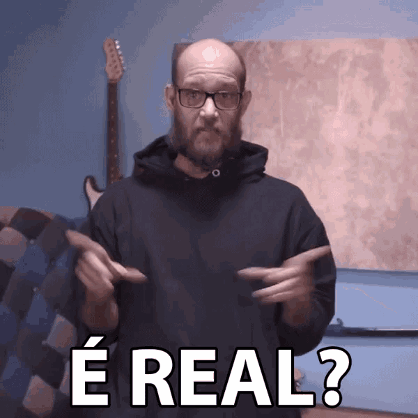 a man with glasses and a beard says " e real "
