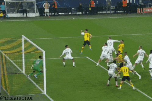 a soccer game is being played on a field with a goalie wearing the number 26