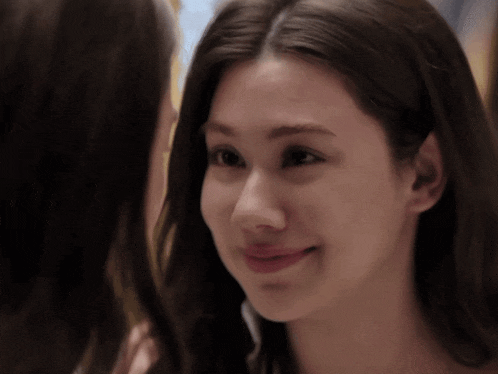 two women are looking at each other in a mirror