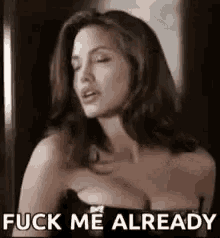 a woman in a black dress is saying `` fuck me already '' while holding her breast .
