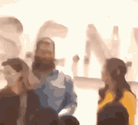 a blurry picture of a group of people standing in front of a sign that says ' sn '