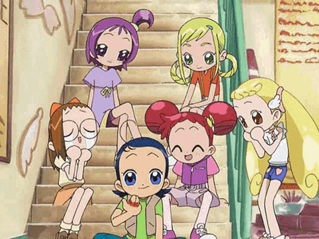 a group of cartoon girls are sitting on a set of stairs .