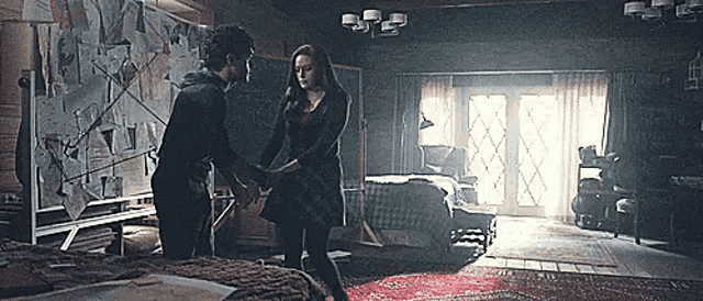 a man and a woman are holding hands in a bedroom with a bed .