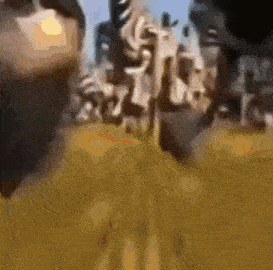 a close up of a person 's face with a blurry background of a city .