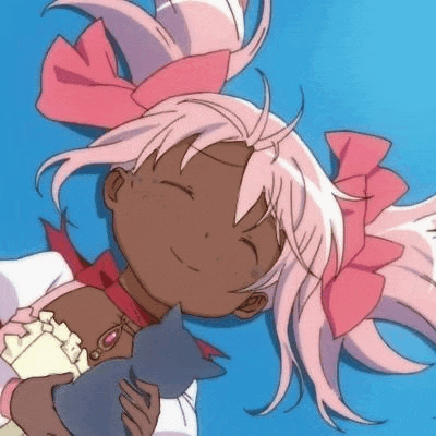 a girl with pink hair is holding a cat and smiling .