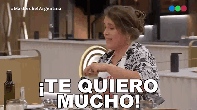 a woman sitting at a table with the words te quiero mucho written on it