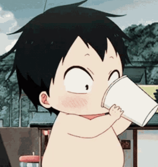 a baby is drinking from a cup and making a face .