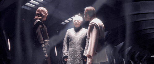 three men are standing next to each other in a hallway