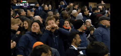 a crowd of people watching a soccer game with the word abs on the bottom right