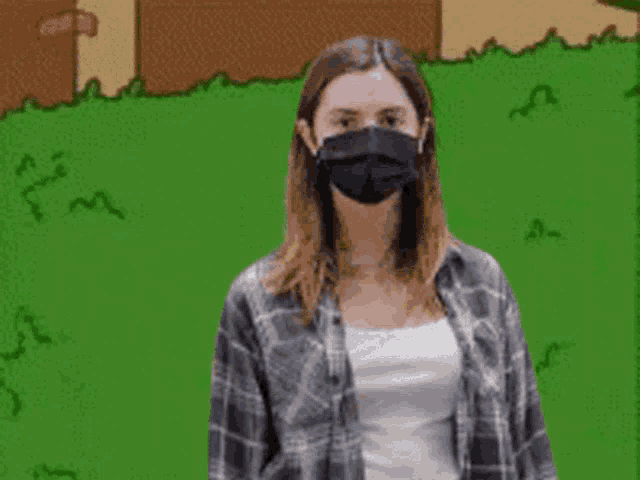 a woman wearing a black face mask and a plaid shirt is standing in front of a cartoon background .