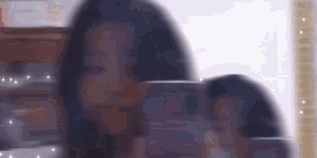 a blurry picture of a woman taking a selfie with her phone .
