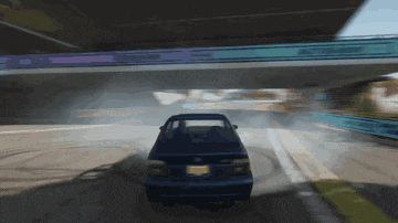 a car is driving under a bridge with smoke coming out of the tires