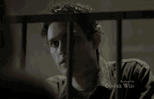 a man behind bars with the name bonnie weis at the bottom