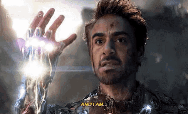 iron man is holding a lightning bolt in his hand and saying `` and i am '' .