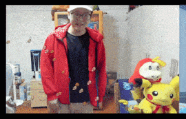 a man in a red jacket is standing in a room with stuffed animals on the floor