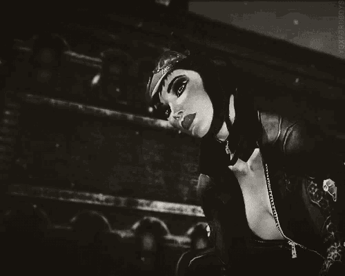a black and white photo of a woman in a catwoman outfit