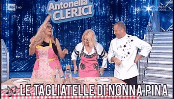 a group of people are dancing in front of a sign that says antonella clerici