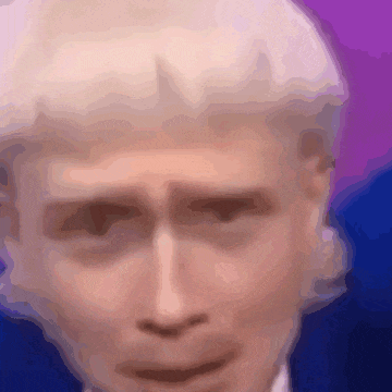a blurry image of a man 's face with a purple background