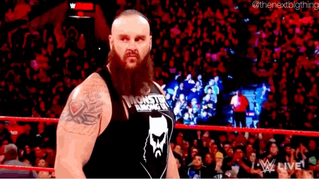 a man with a beard is wearing a black tank top that says ' heavyweight knockout ' on it