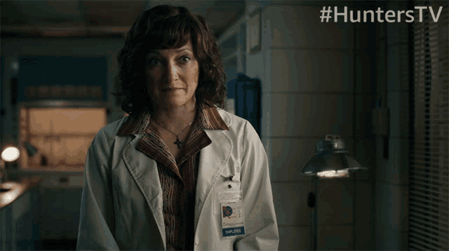 a woman in a lab coat has a name tag that says hunterstv on it