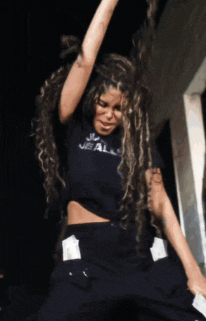 a woman in a jealous shirt is dancing