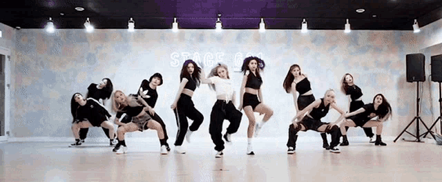 a group of women are dancing in a dance studio