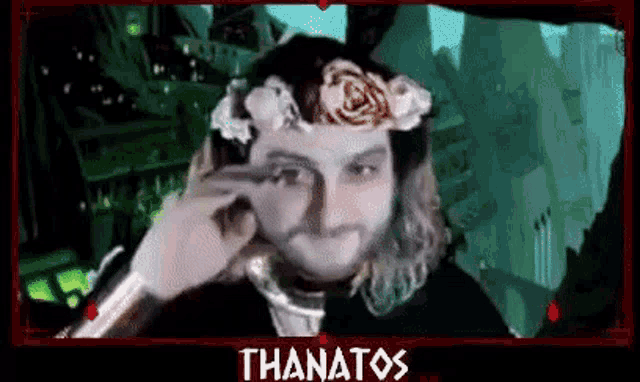a man with a flower crown on his head is crying .