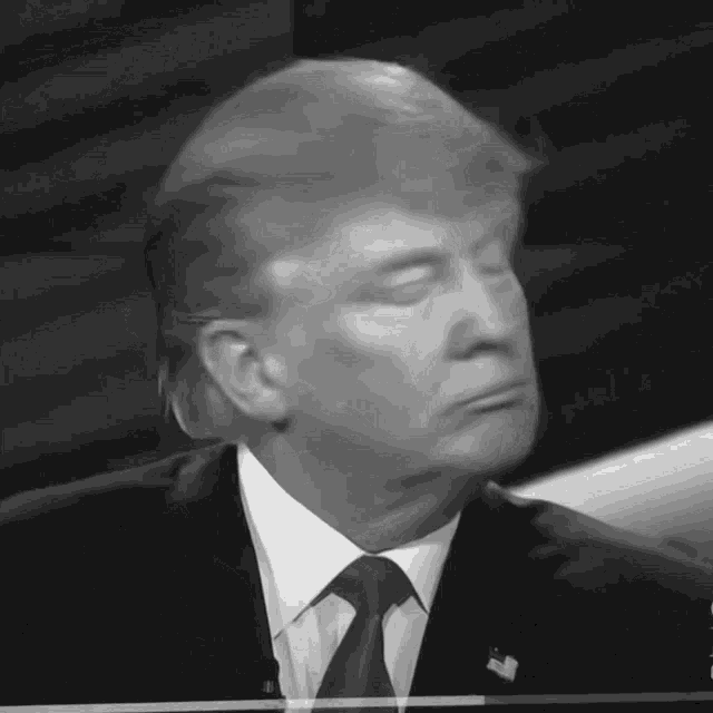 a close up of donald trump 's face with his eyes closed