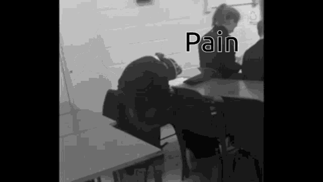a black and white photo of people in a classroom with the word pain written on the bottom