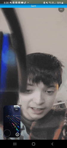 a boy is playing a video game on a cell phone screen