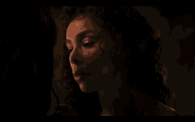 a woman with curly hair is looking at another woman