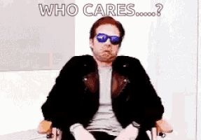 a man wearing sunglasses and a leather jacket is sitting in a chair .