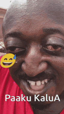 a close up of a man 's face with a smiley face on his forehead that says paaku kaula