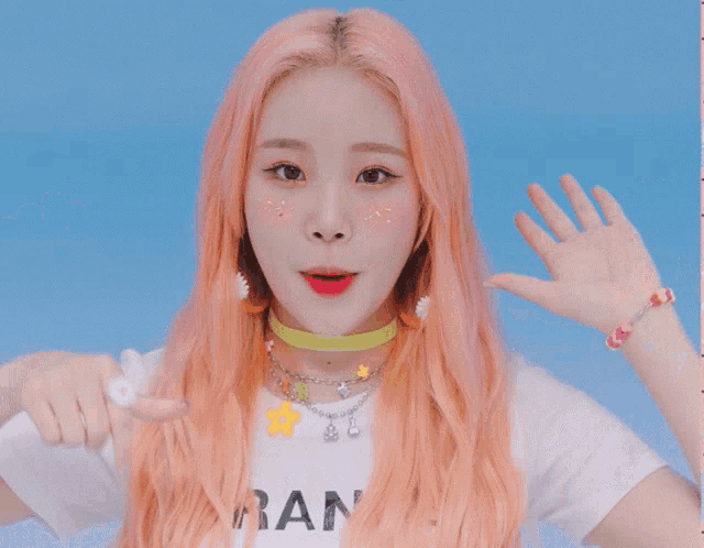a woman with pink hair wearing a white t-shirt that says ran